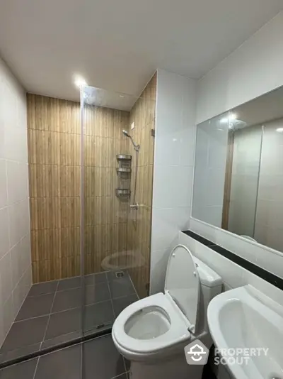 Modern bathroom with sleek glass shower and stylish wooden accents