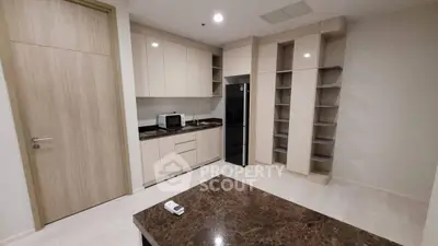 Modern kitchen with sleek cabinets and marble countertop in a stylish apartment