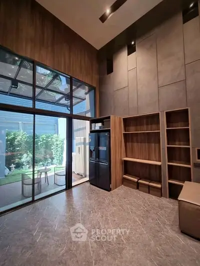 Spacious modern living room with high ceilings and garden view