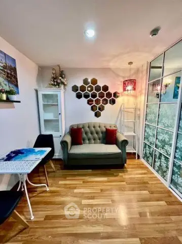 Charming living room with stylish decor and cozy seating in modern apartment.