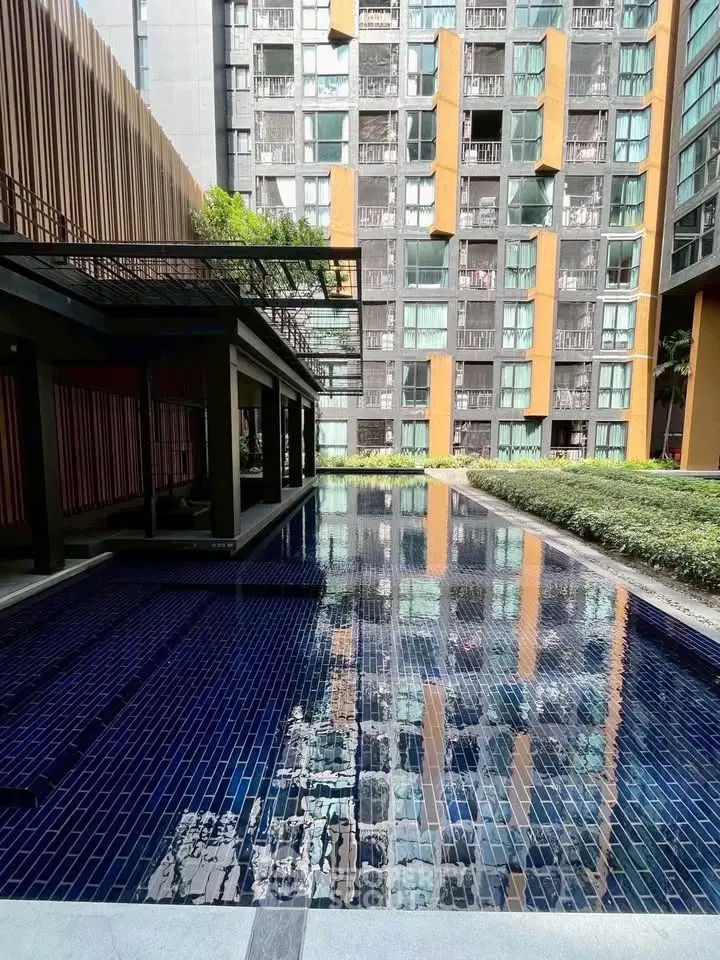 Modern apartment building with stylish pool and lush greenery