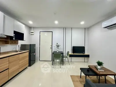 Modern open-plan living room with sleek kitchen and cozy dining area