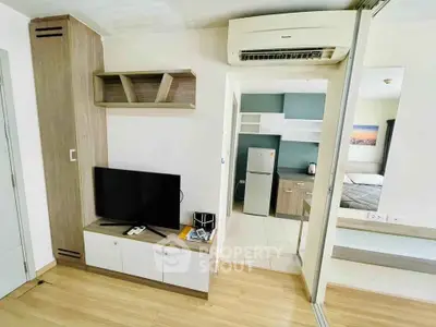 Modern apartment interior with open layout, featuring a cozy living area and compact kitchen.