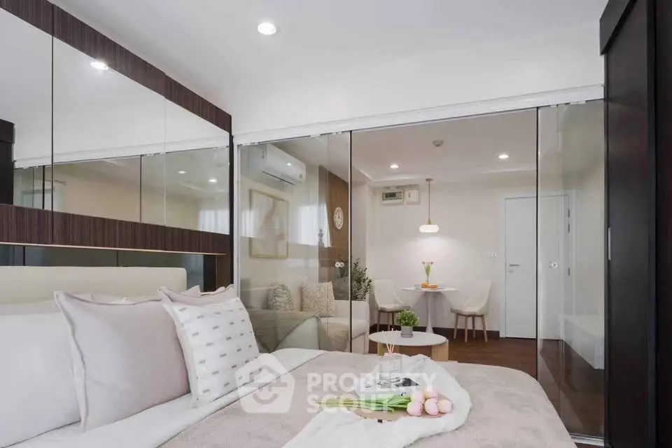 Modern bedroom with glass partition and cozy living area