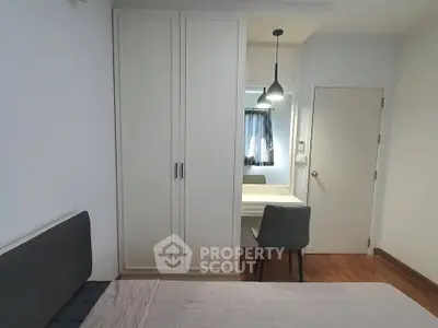 Modern bedroom with sleek wardrobe and cozy study nook