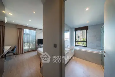 Modern apartment interior with spacious bedroom and luxurious bathroom featuring a bathtub and city view.
