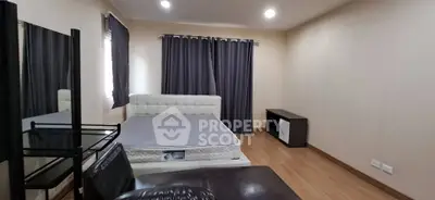 Spacious bedroom with modern decor and ample natural light