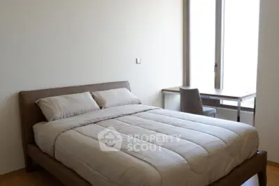 Modern bedroom with cozy bed and study desk by large window, perfect for relaxation and productivity.