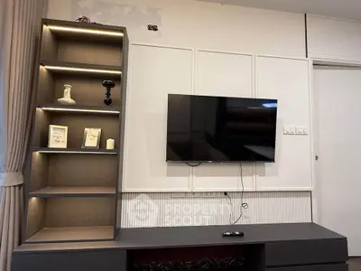 Modern living room with wall-mounted TV and stylish shelving unit