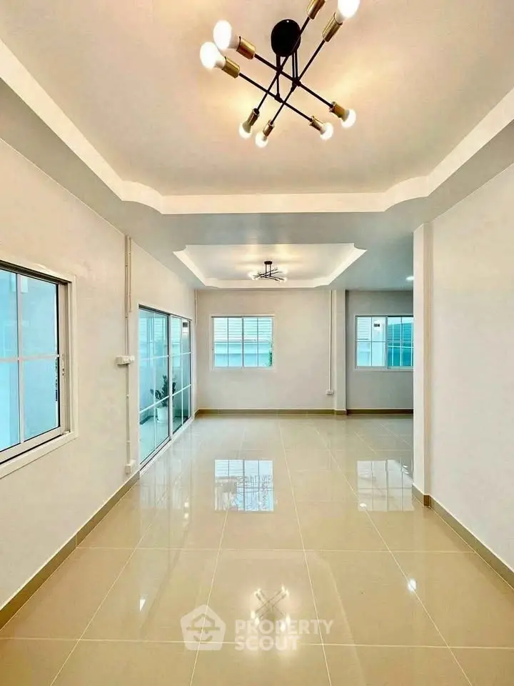 Spacious modern living room with elegant lighting and large windows