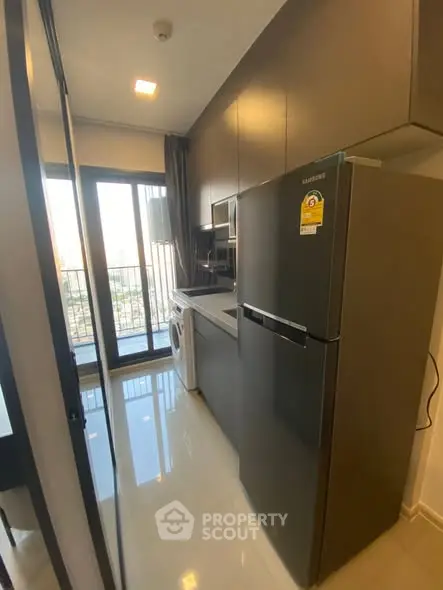 Modern kitchen with sleek appliances and balcony view