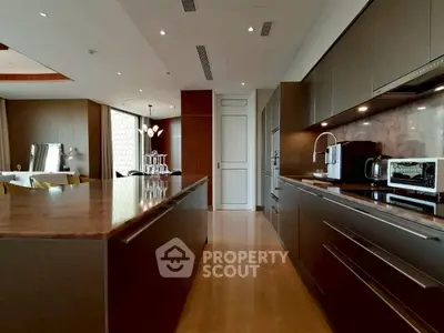Luxurious modern kitchen with sleek cabinetry and high-end appliances in a spacious open layout.