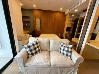 Modern studio apartment with cozy sofa and stylish wooden accents