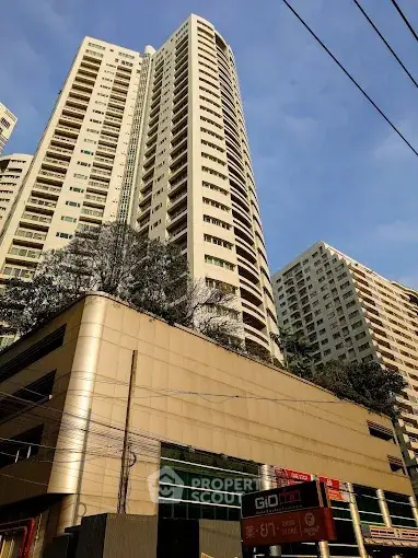 Stunning high-rise residential building with modern architecture and lush greenery.