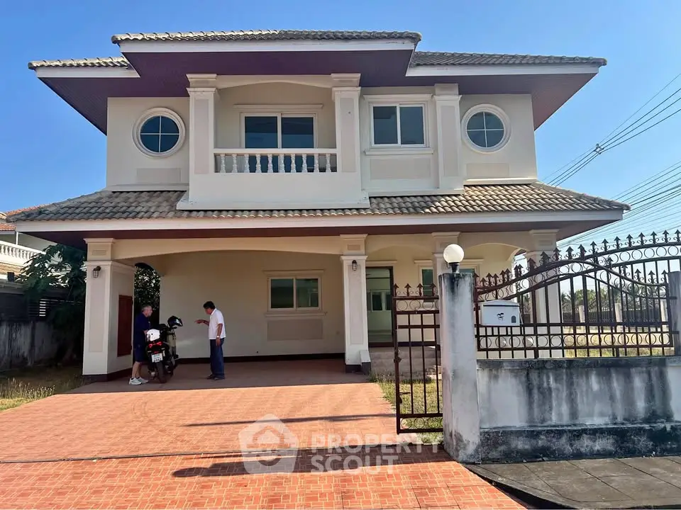 Charming two-story house with spacious driveway and elegant balcony in a serene neighborhood.