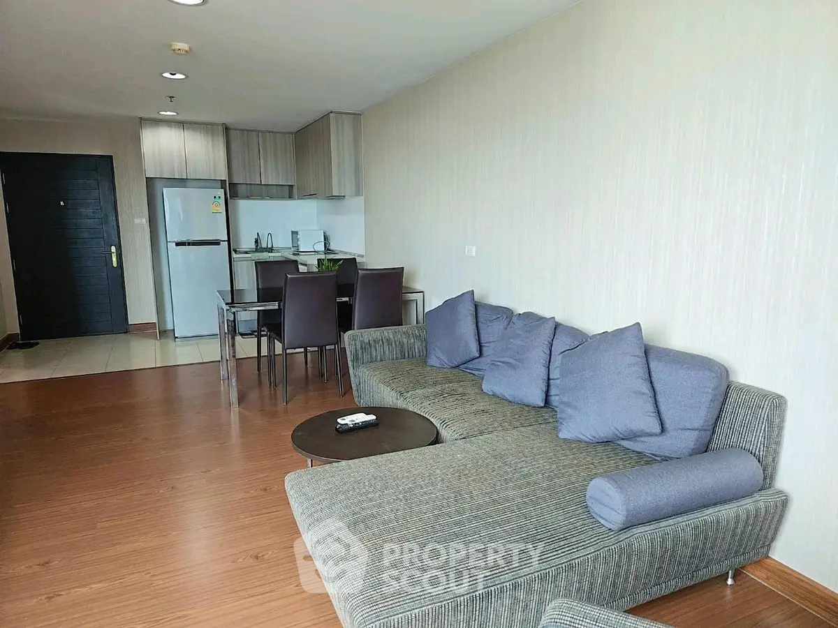 Spacious modern living room with open kitchen and stylish furniture in a contemporary apartment.