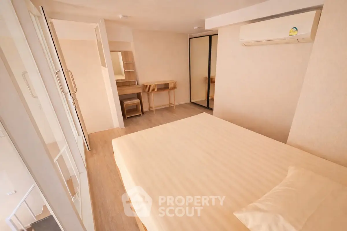 Spacious bedroom with modern furnishings and air conditioning