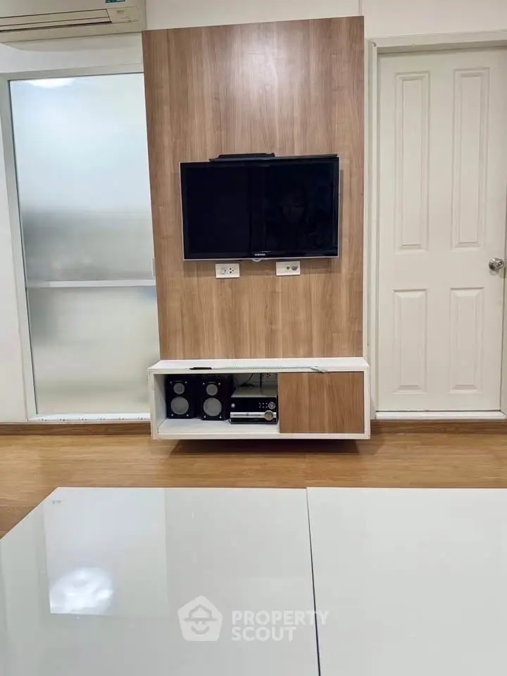 Modern living room with wall-mounted TV and sleek wooden paneling