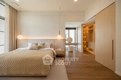 Luxurious modern bedroom with elegant lighting and spacious walk-in closet.