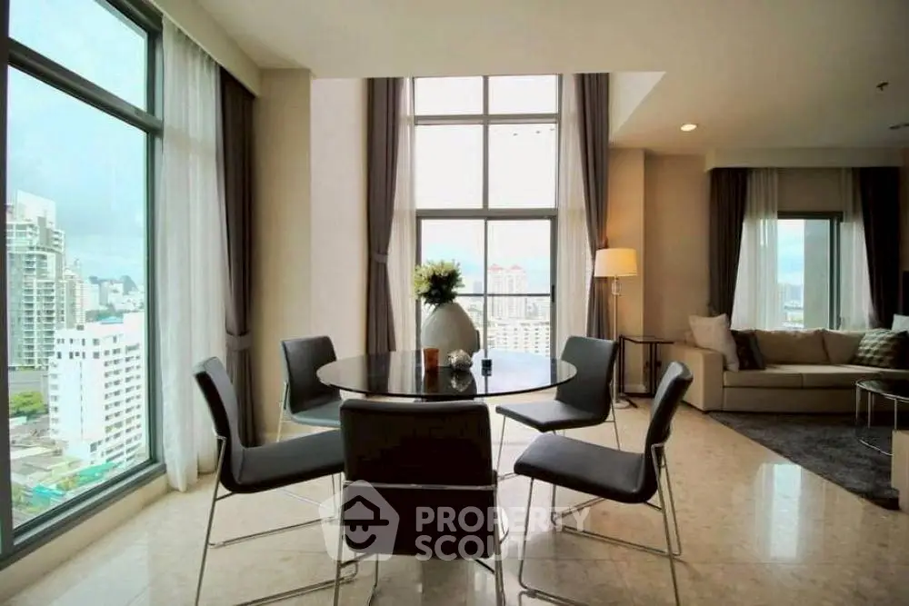 Luxurious high-rise living room with panoramic city views and elegant decor.