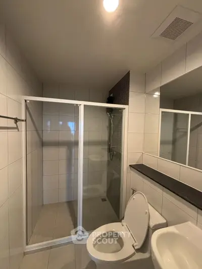 Modern bathroom with glass shower and sleek tile design