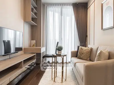Modern living room with cozy sofa, stylish decor, and natural light through large windows.