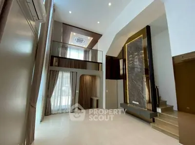Luxurious modern living room with high ceilings and mezzanine level