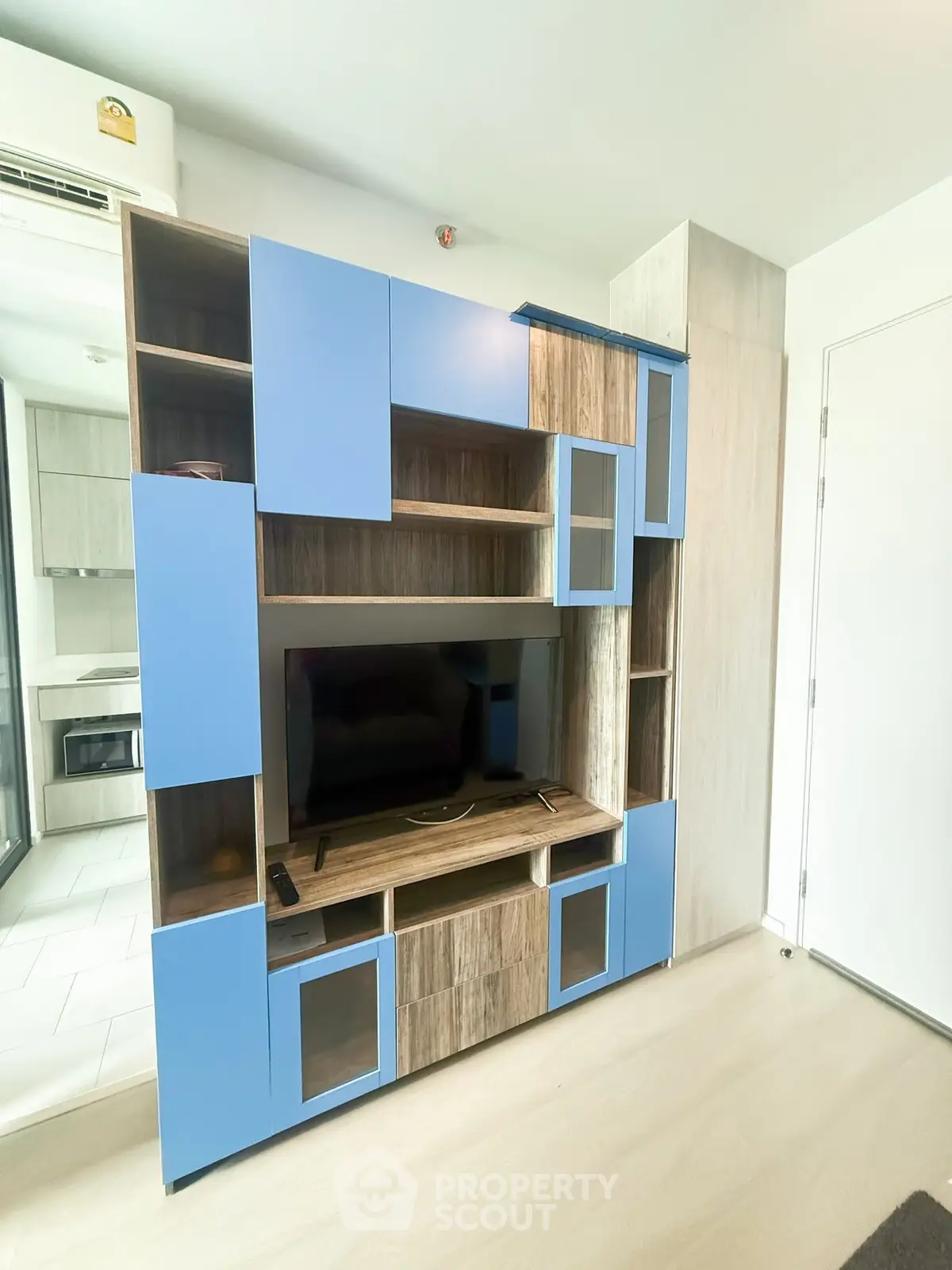 Modern living room with stylish blue and wood entertainment center