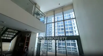 Spacious modern living room with floor-to-ceiling windows and stunning city view