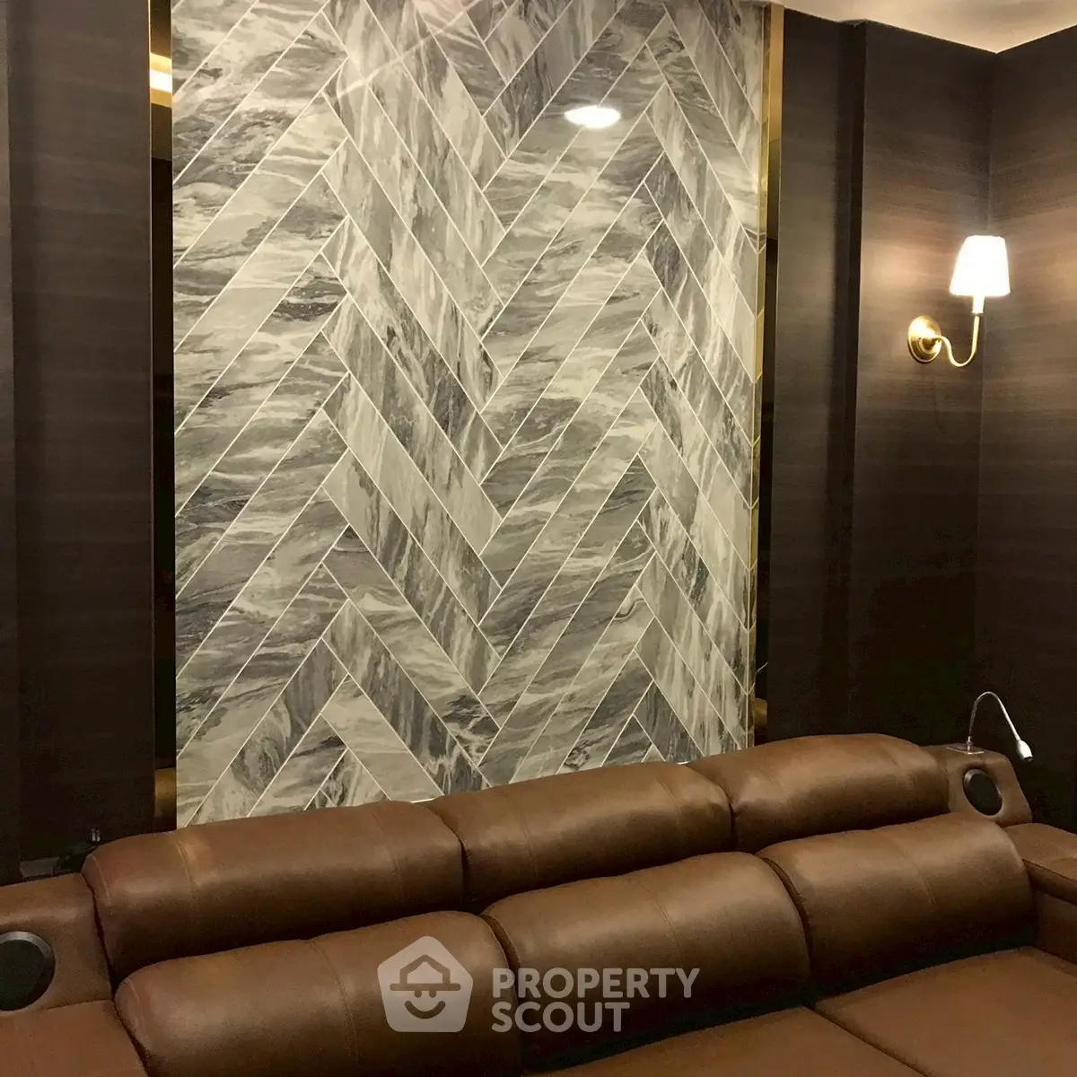 Luxurious living room with elegant herringbone accent wall and plush leather sofa.