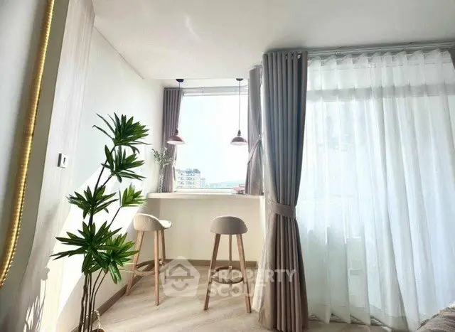 Bright and airy corner unit with stylish bar seating and large windows.