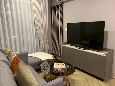 Modern living room with sleek furniture and large TV, perfect for relaxation.