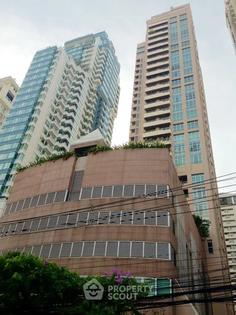 Stunning high-rise buildings with modern architecture and lush greenery in urban setting.