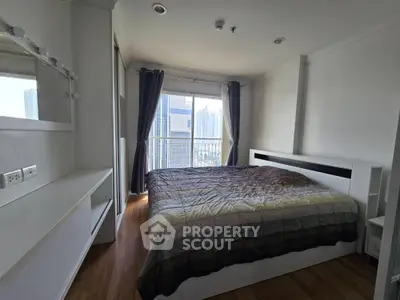 Modern bedroom with city view and stylish decor in high-rise apartment