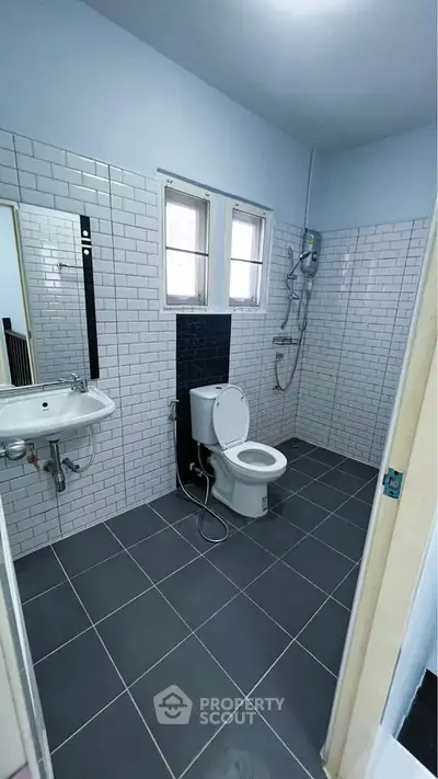 Modern bathroom with sleek white tiles and contemporary fixtures