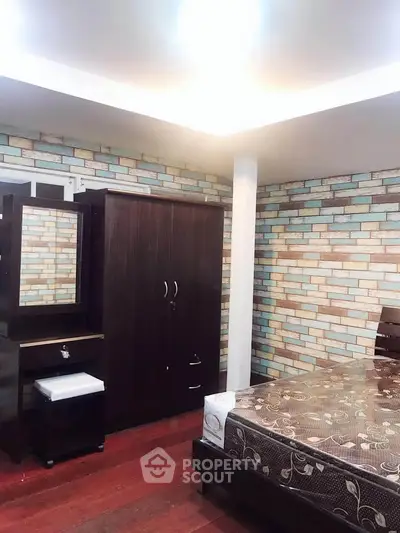 Cozy bedroom with modern furniture and stylish brick accent wall