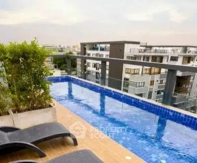 Luxurious rooftop pool with stunning city views in modern apartment complex.