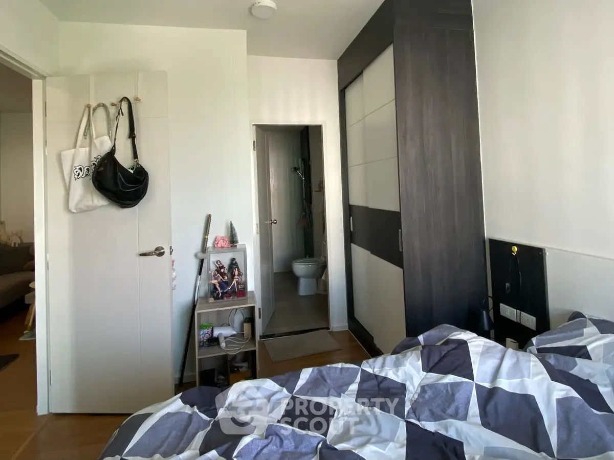 Cozy bedroom with modern wardrobe and ensuite bathroom, perfect for comfortable living.