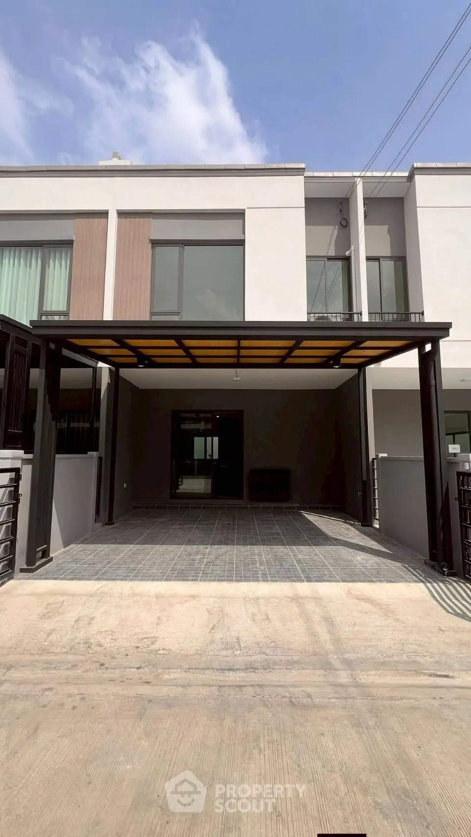 Modern townhouse with spacious carport and sleek design