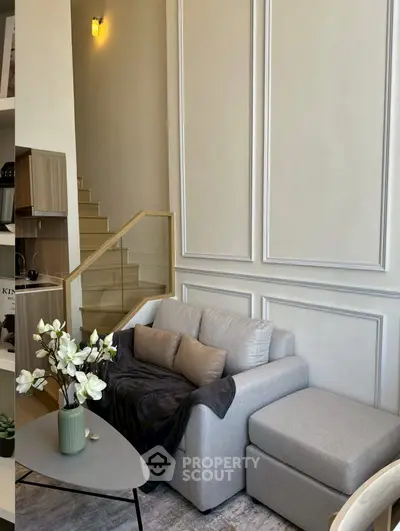 Modern living room with elegant staircase and cozy seating area