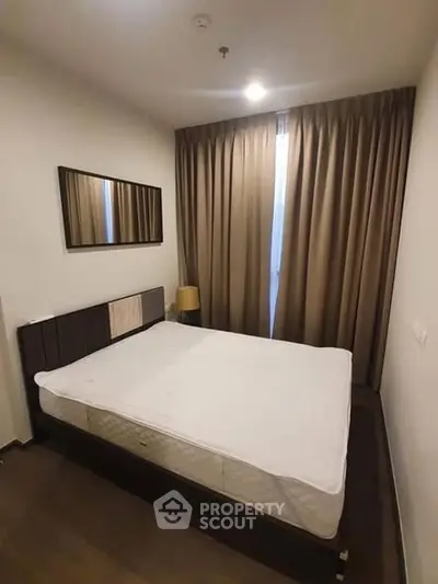 Cozy bedroom with modern decor and ample natural light.