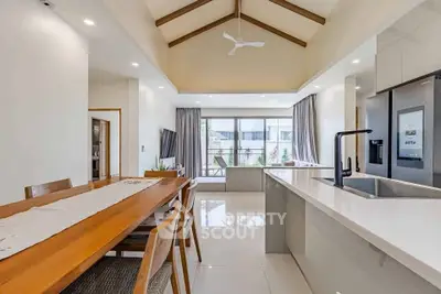 Spacious modern kitchen and dining area with high ceilings and natural light.