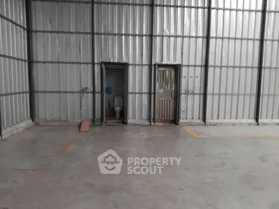 Spacious industrial warehouse with attached restroom facilities, ideal for storage and logistics operations.