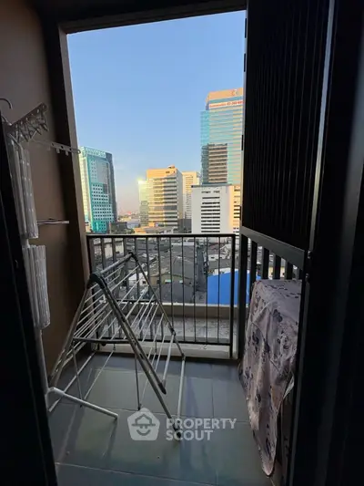 Urban balcony with city skyline view and drying racks