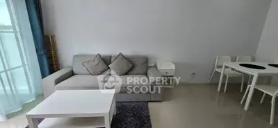 Modern living room with cozy gray sofa and dining area