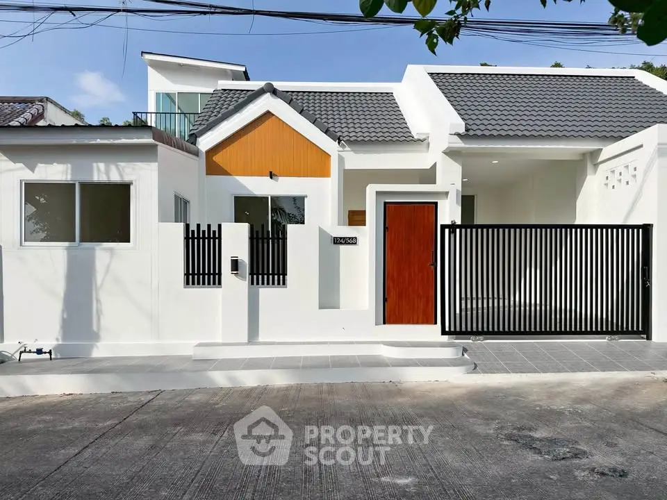Modern white house exterior with sleek gate and contemporary design.