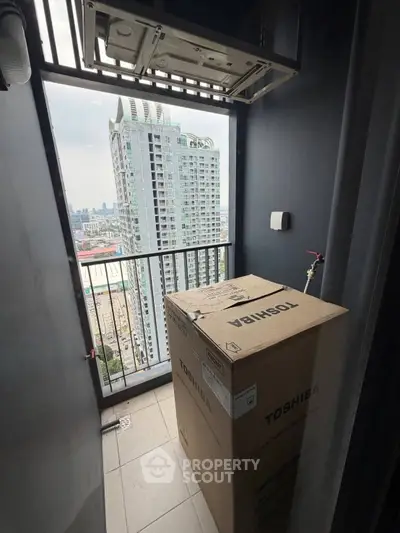High-rise balcony with city view and Toshiba appliance box, ideal for urban living.