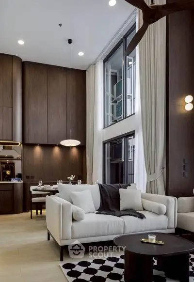Luxurious modern living room with high ceilings and elegant decor in a stylish apartment.