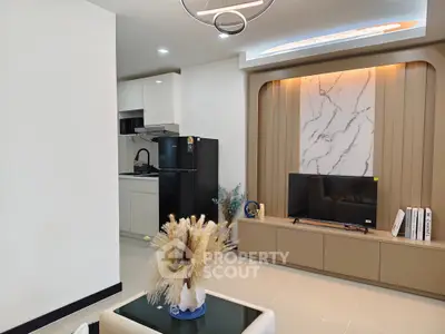 Modern living room with sleek kitchen and stylish decor