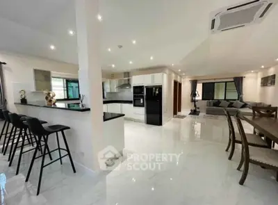 Spacious open-plan kitchen and living area with modern furnishings and sleek design.